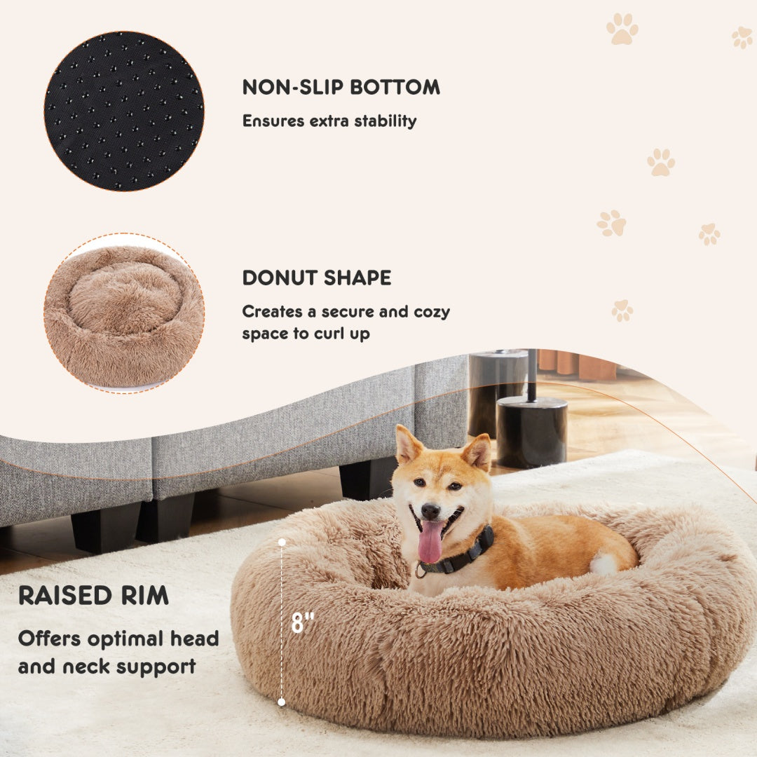 Tan donut pet bed showing the raised rim, round shape, and nonslip base
