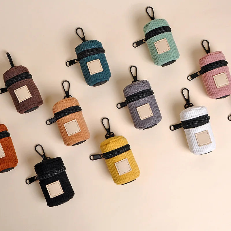 Flat lay of corduroy dog poop bag holders in assorted colors