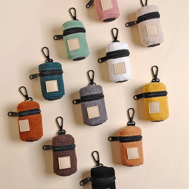 Corduroy dog poop bag holders arranged in assorted colors
