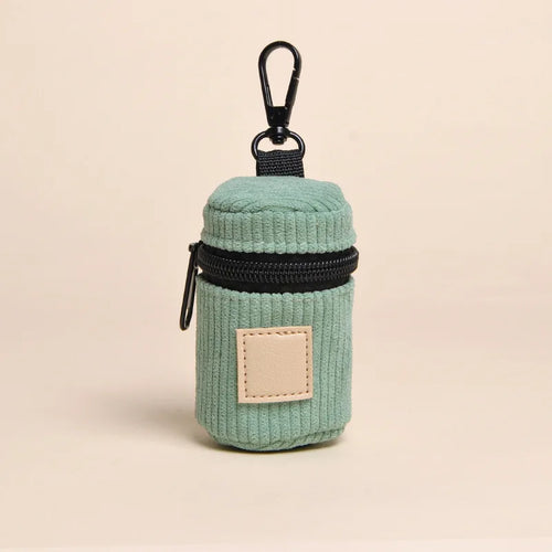 Sage green corduroy dog poop bag holder with a black zipper and clip