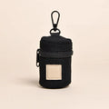 Black corduroy dog poop bag holder with a black zipper and clip