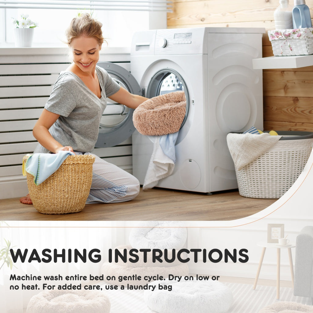 Donut pet bed washing instructions beside a person loading a washing machine